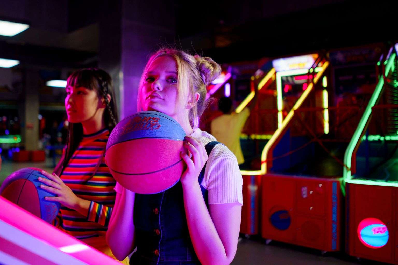 Basketball players competing on an indoor hardwood court