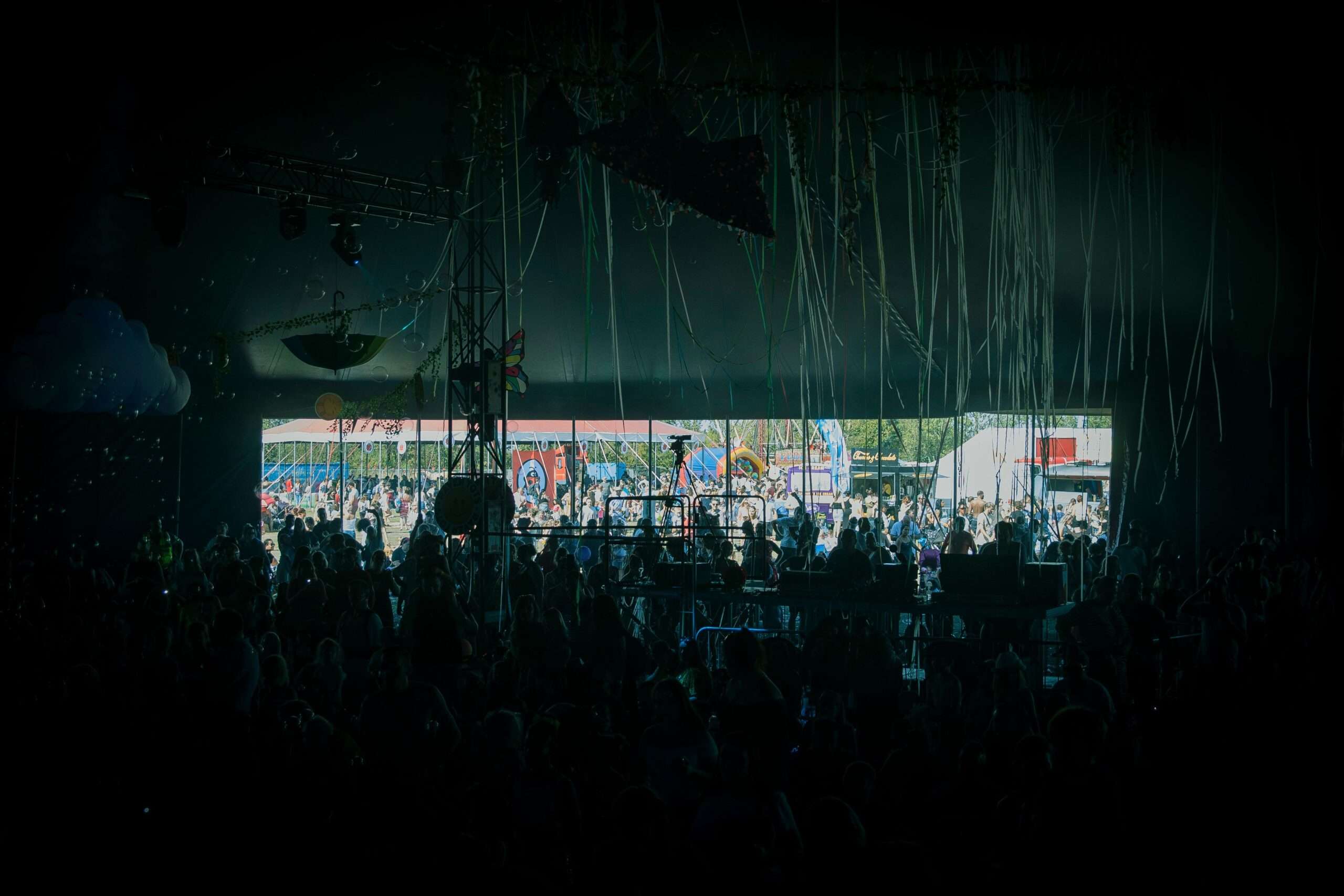 Crowd of festivalgoers gathered in front of an outdoor concert stage