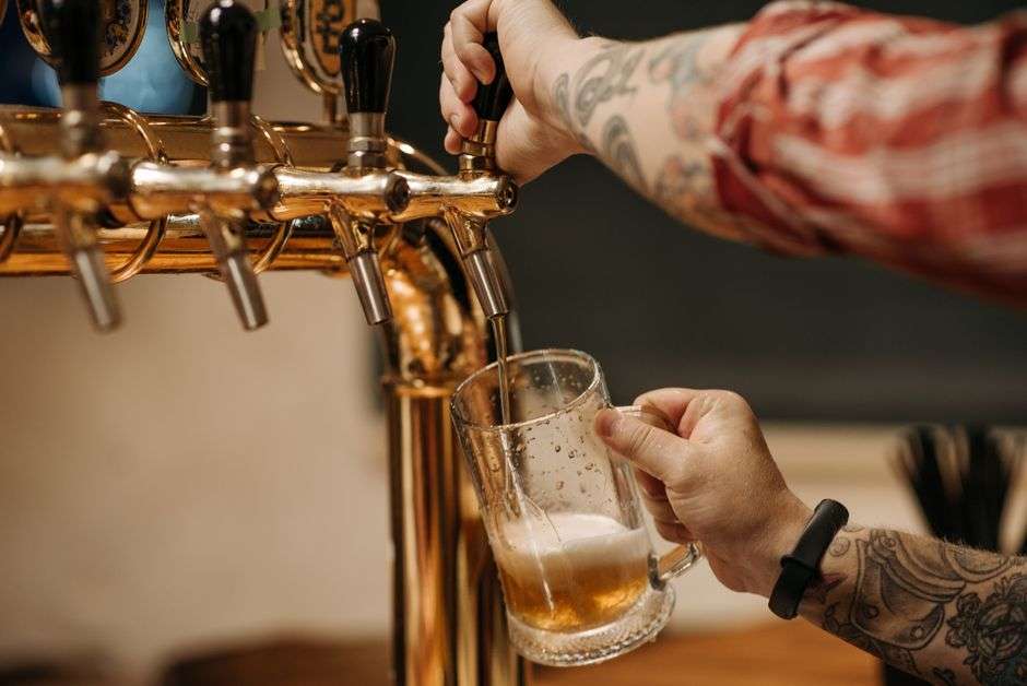 A bartender pours a craft beer at a brewpub taproom