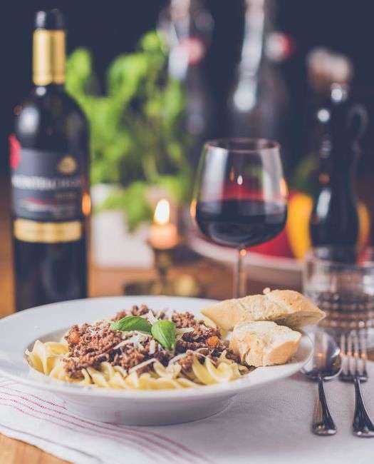 Plate of Italian pasta served at a restaurant table