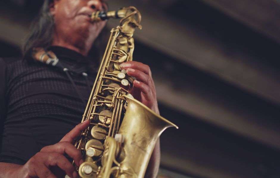 A saxophonist plays a gold saxophone during a live jazz performance