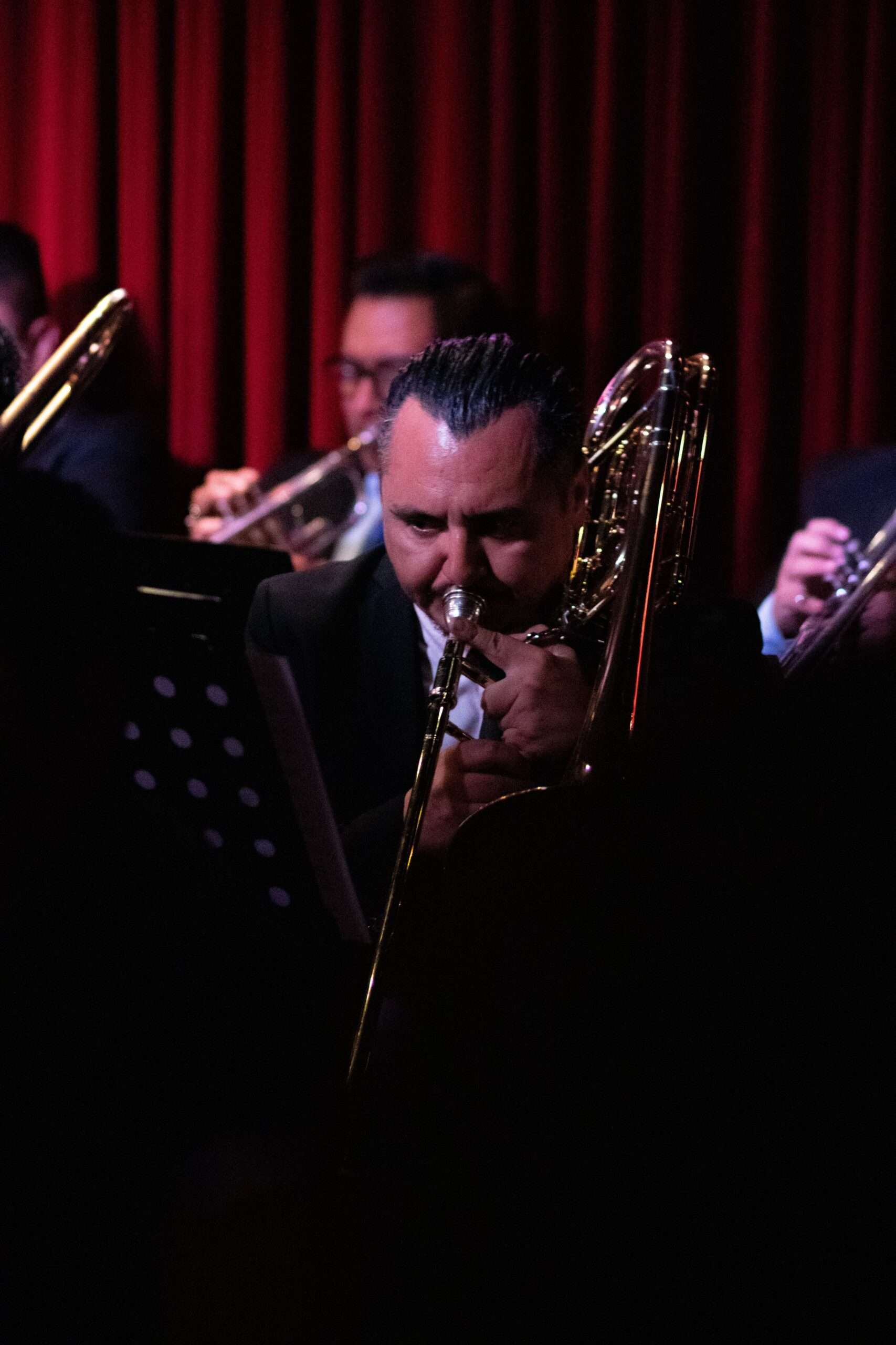 A jazz trombonist performing on stage, representing the trombone tradition celebrated during Jazz Appreciation Month