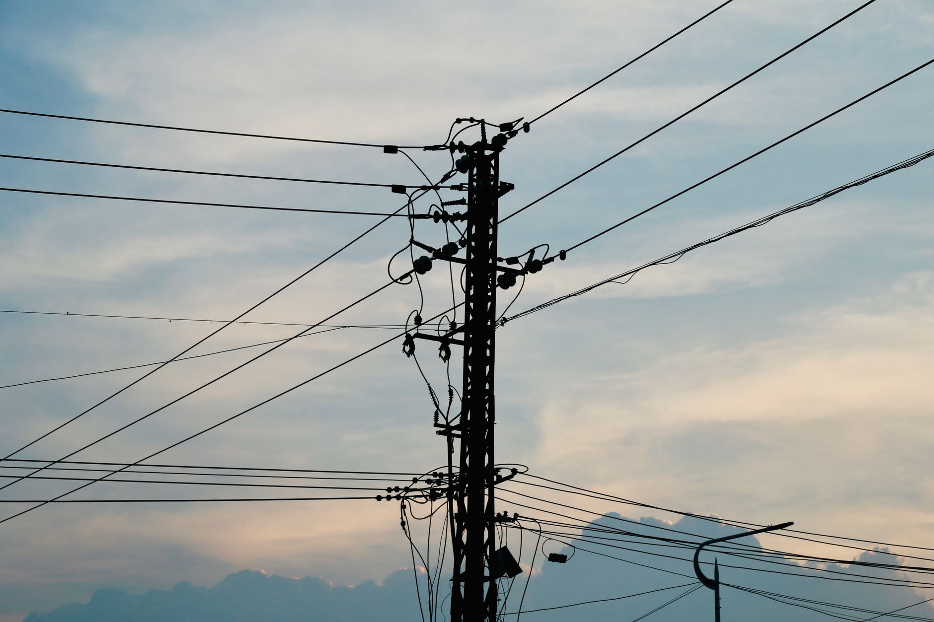 High-voltage electric transmission lines against the sky
