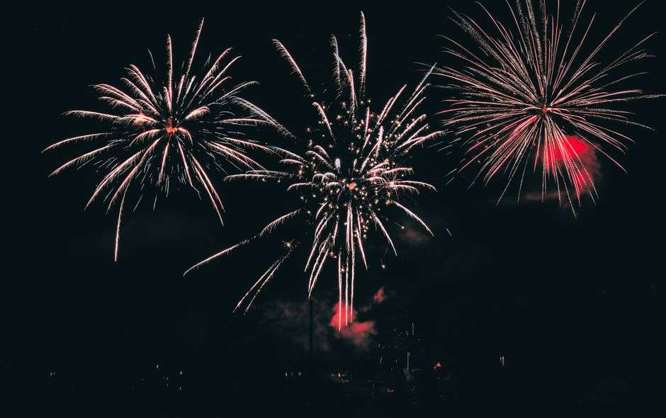 Fireworks lighting up the night sky over a Fourth of July celebration