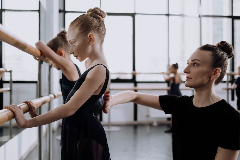 A ballet instructor teaching a dance class