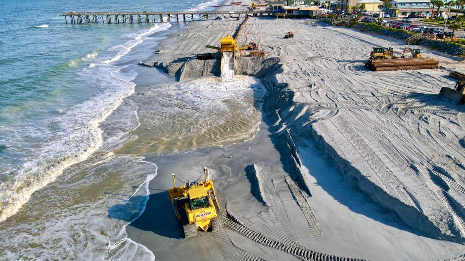 Sand being pumped onto a beach shoreline