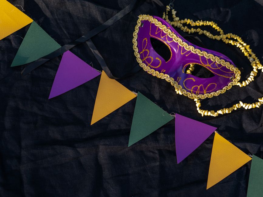 Ornate Mardi Gras king and queen costumes with elaborate trains
