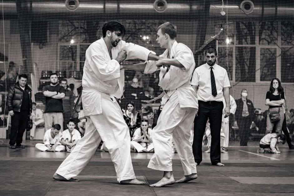 Martial arts competitors sparring during a tournament match