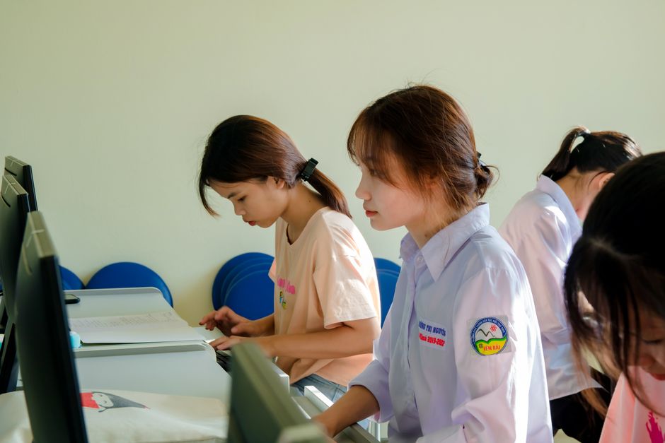 High school student working on a computer in a technology classroom