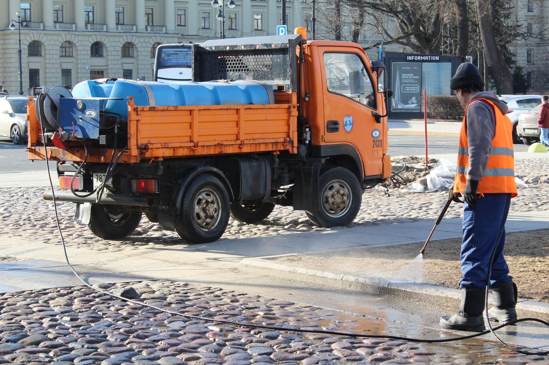 White utility service truck parked along a residential street