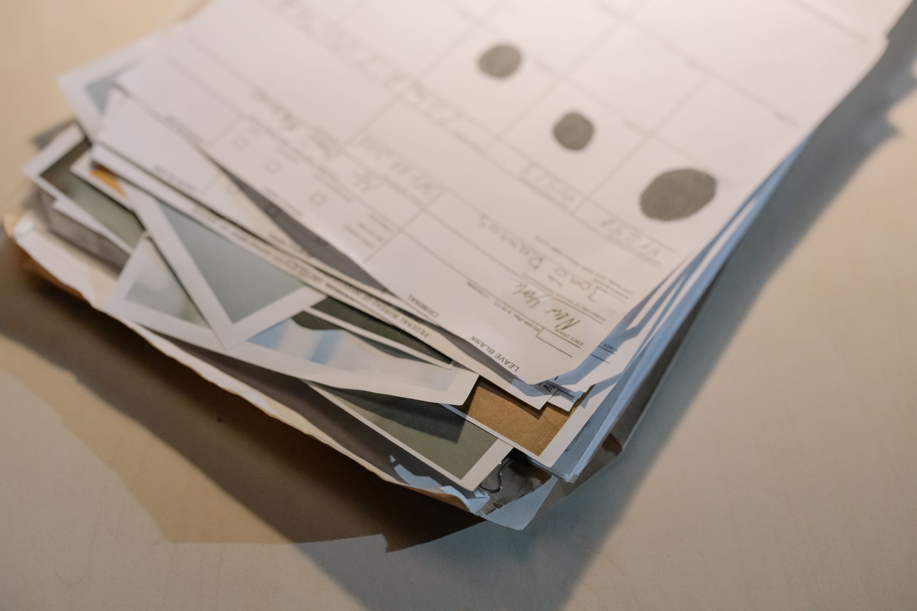A stack of printed contract documents on a desk