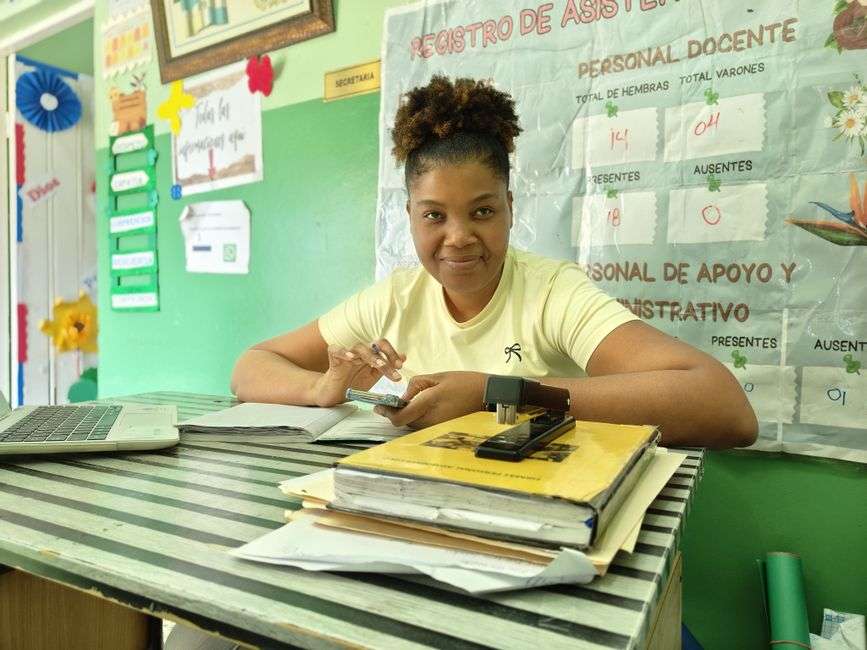 A teacher works at a desk in a Mobile County classroom
