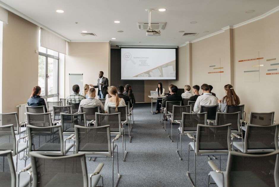 A group of school administrators sit in rows during a safety training presentation