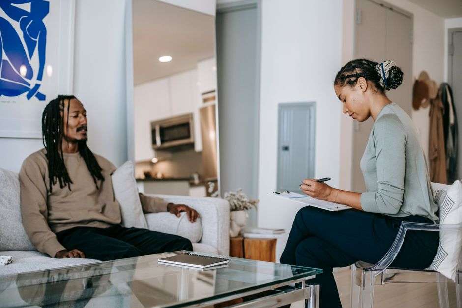 A counselor speaks with a client during a behavioral health therapy session