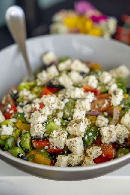 A fresh Mediterranean-style bowl with grilled meat, rice and vegetables