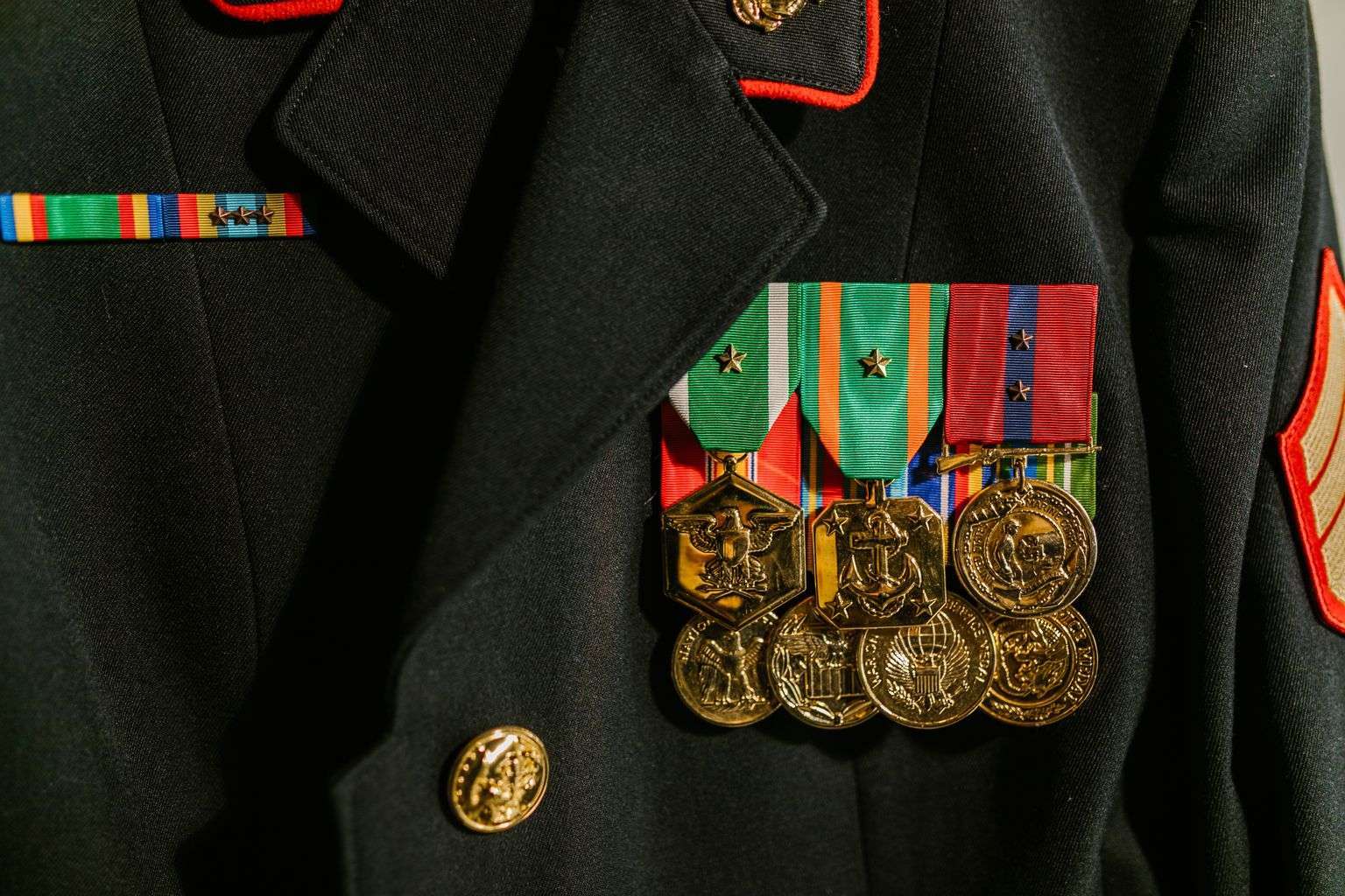 Close-up of military service medals and ribbons pinned to a uniform
