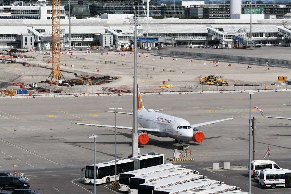 Construction equipment and an airplane at an airport terminal building site