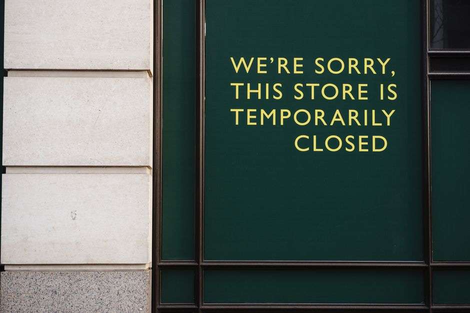 A closed sign posted on a storefront window during coronavirus-related business restrictions