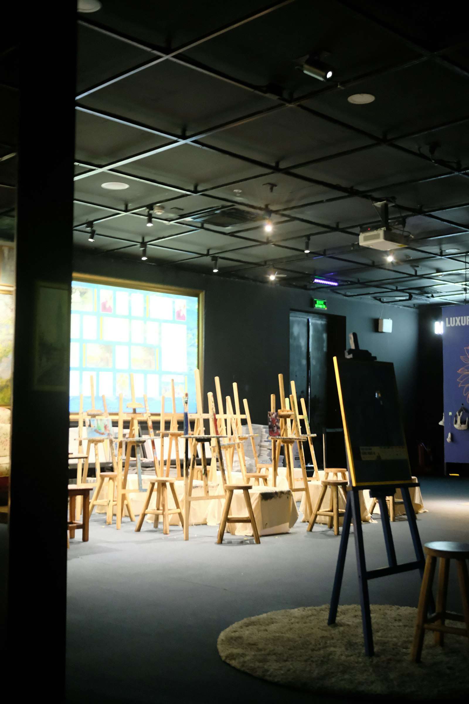 Art studio with easels and paintings on display, similar to the gallery setting for the upcoming show