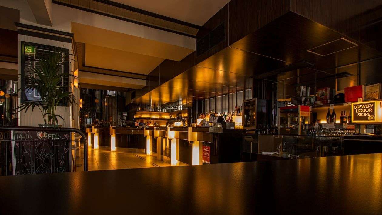 Interior of a bar and nightclub with warm lighting, similar to downtown Mobile nightlife venues
