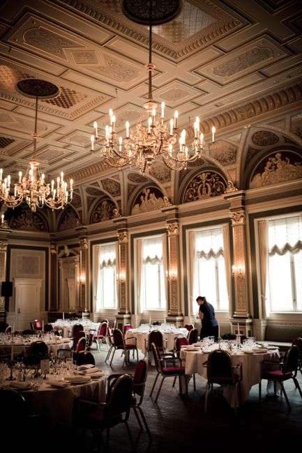 A decorated hotel ballroom set up for a formal evening event