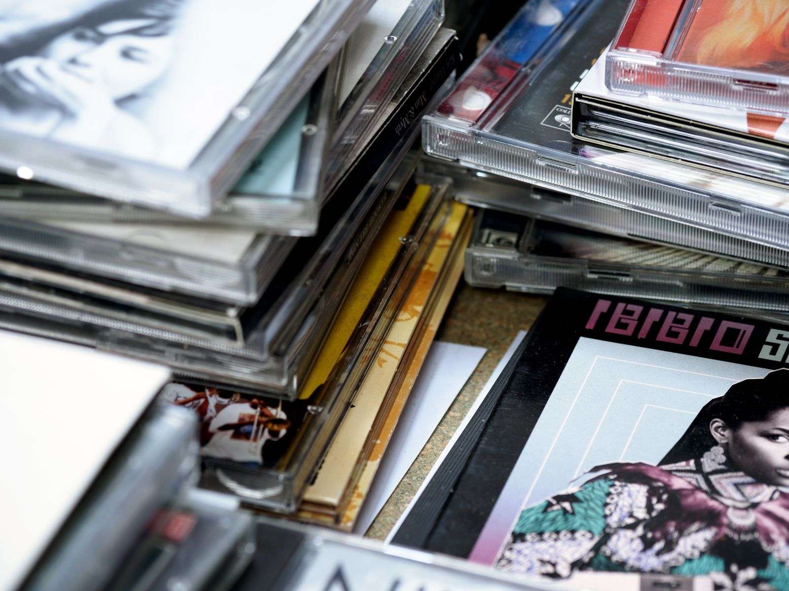 A stack of music CDs representing the wave of local album releases from Mobile Bay musicians in 2009