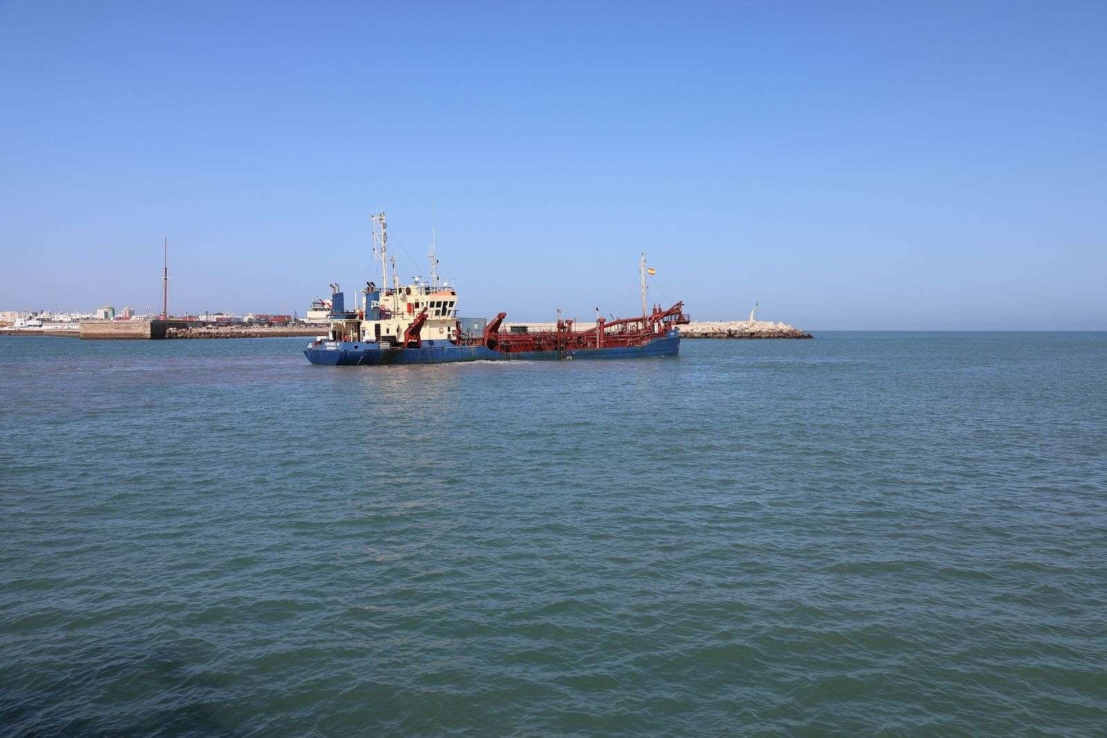 Dredging vessel operating in a coastal port