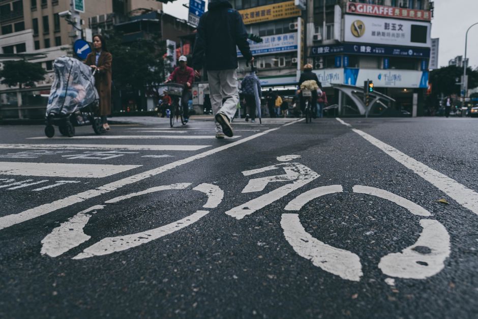 Bicyclists riding on a downtown Mobile street with marked bike lanes