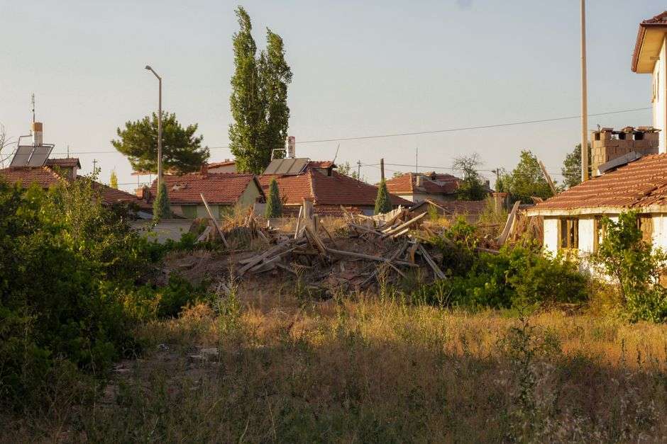 An overgrown, vacant blighted house sits abandoned, the type of structure targeted for demolition