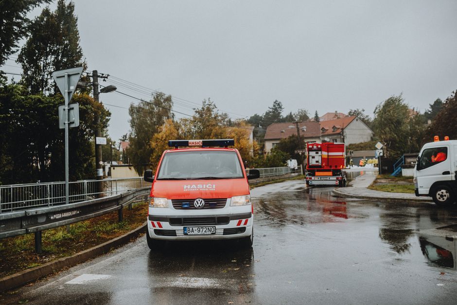 Fire and rescue vehicles parked on a residential street responding to a car crash into a home