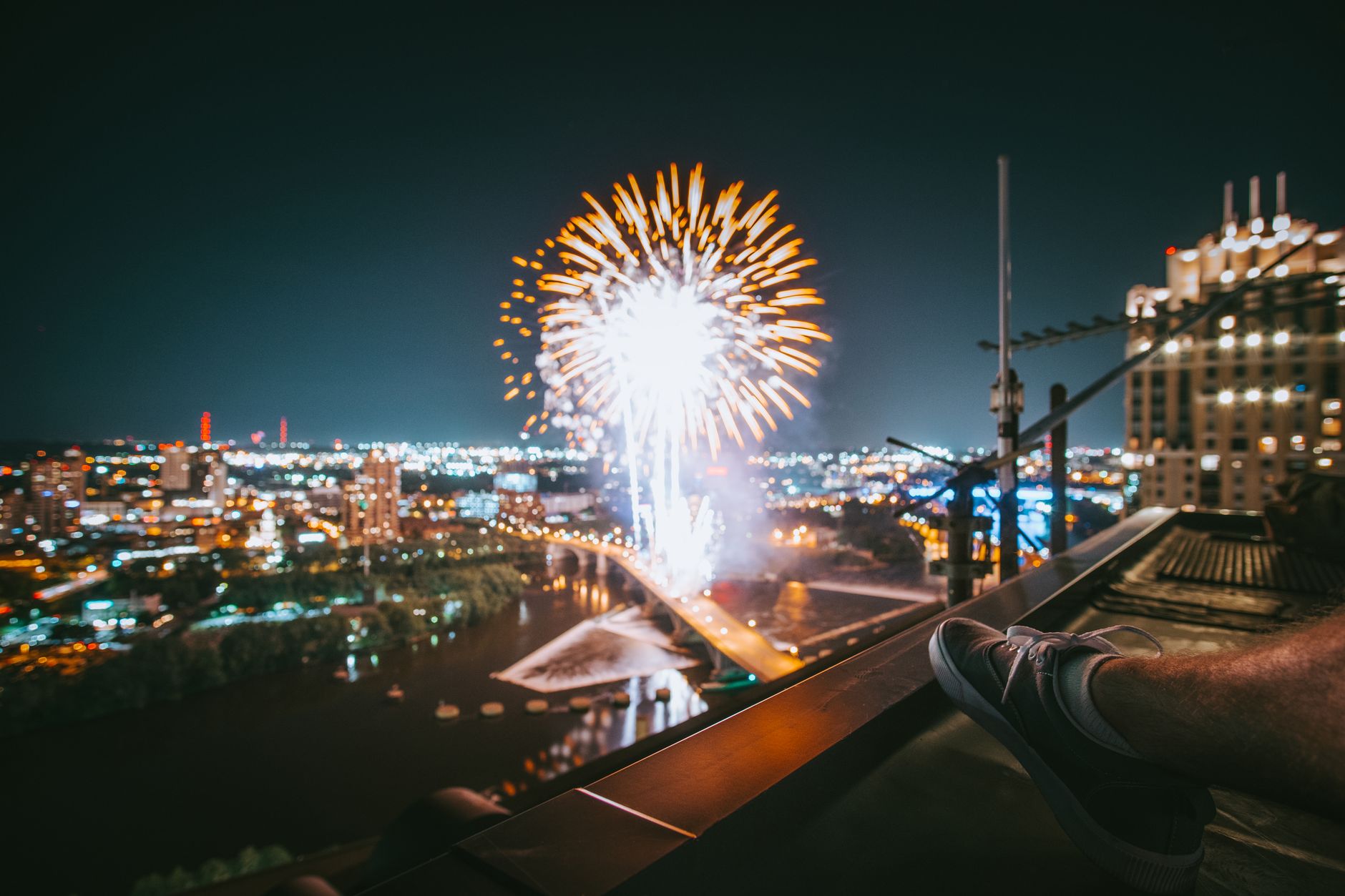 Fireworks bursting over a city skyline at night