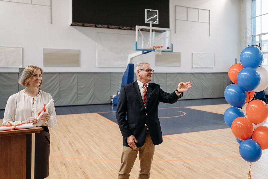 A high school gymnasium set up for a public meeting, representative of the Mobile City Council's session at B.C. Rain High School