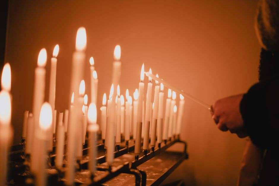 Rows of lit candles at a community vigil