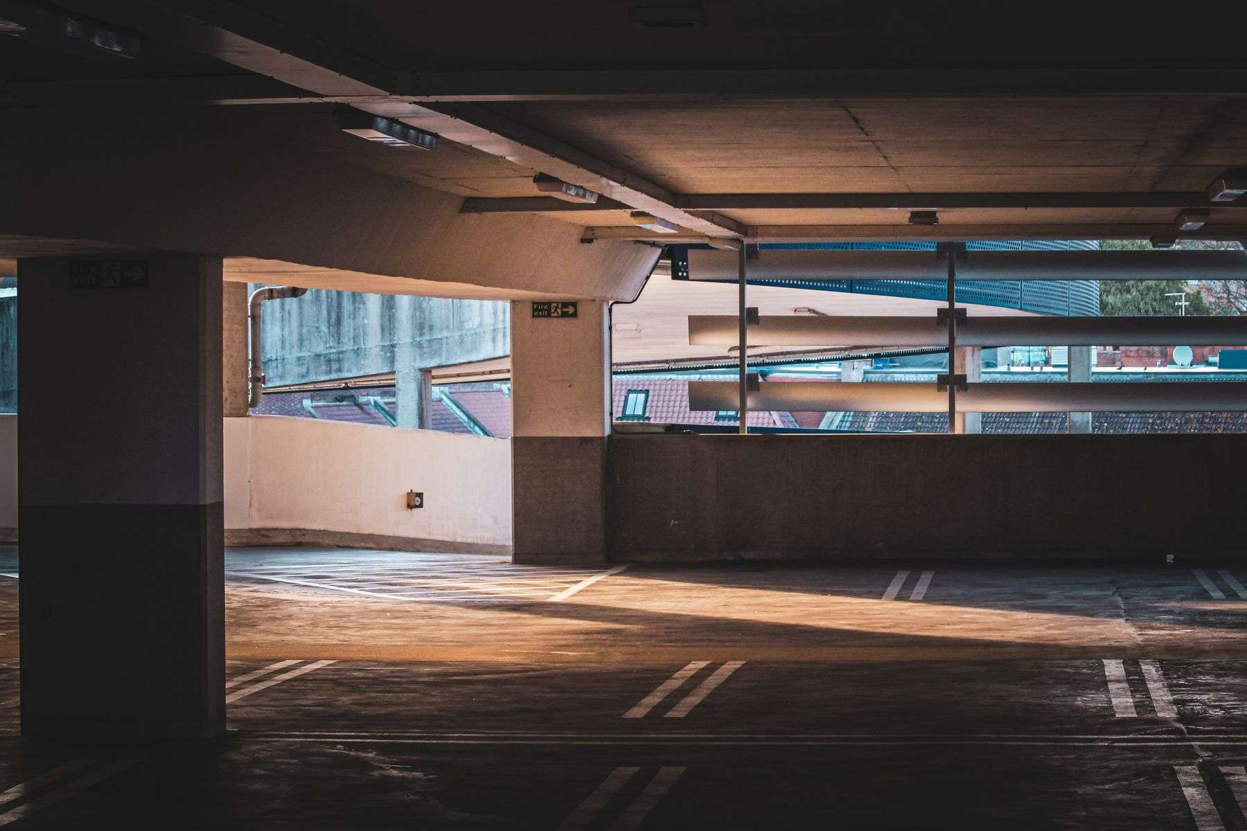 Sunlit interior of a multistory parking garage with rows of parking spaces