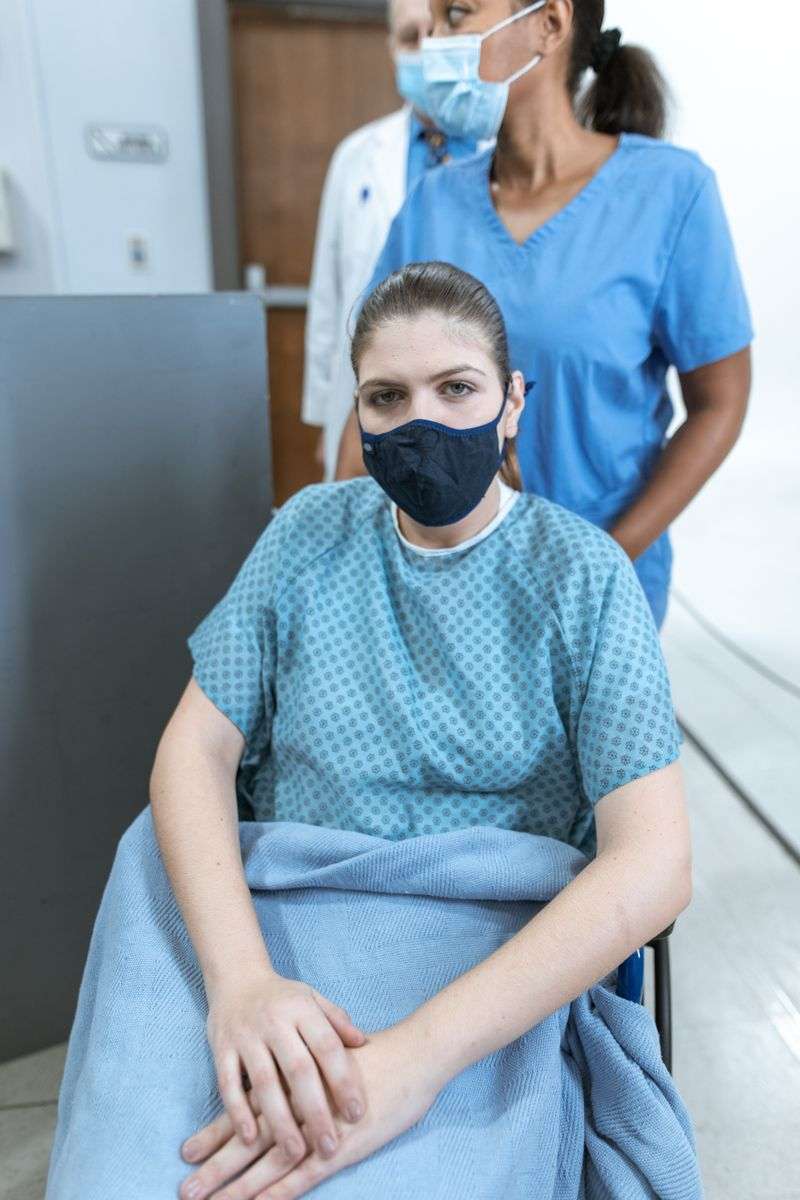 A healthcare worker wearing a protective face mask in a hospital setting