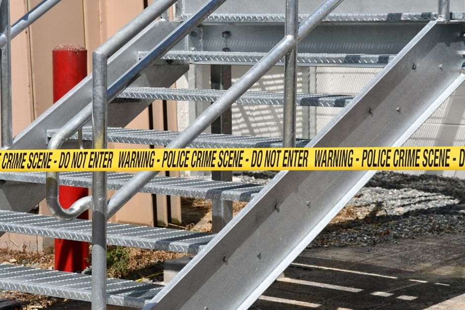Yellow police crime scene tape marks off an investigation area
