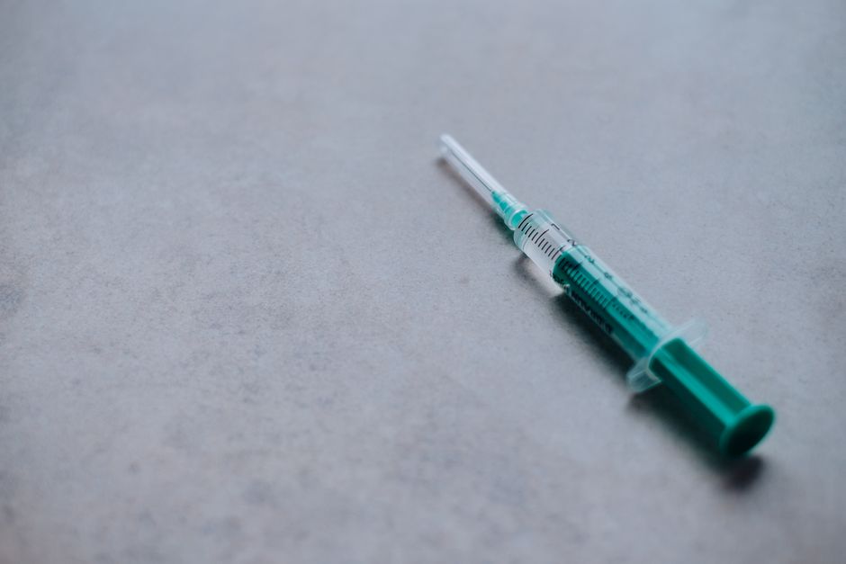 A health care worker administering a flu vaccine at a clinic