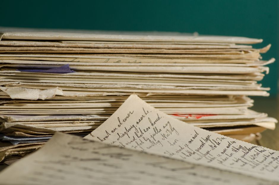 An aged handwritten historical document on a wooden desk