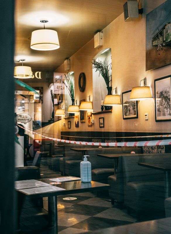 Empty restaurant dining area with tables closed off due to coronavirus restrictions