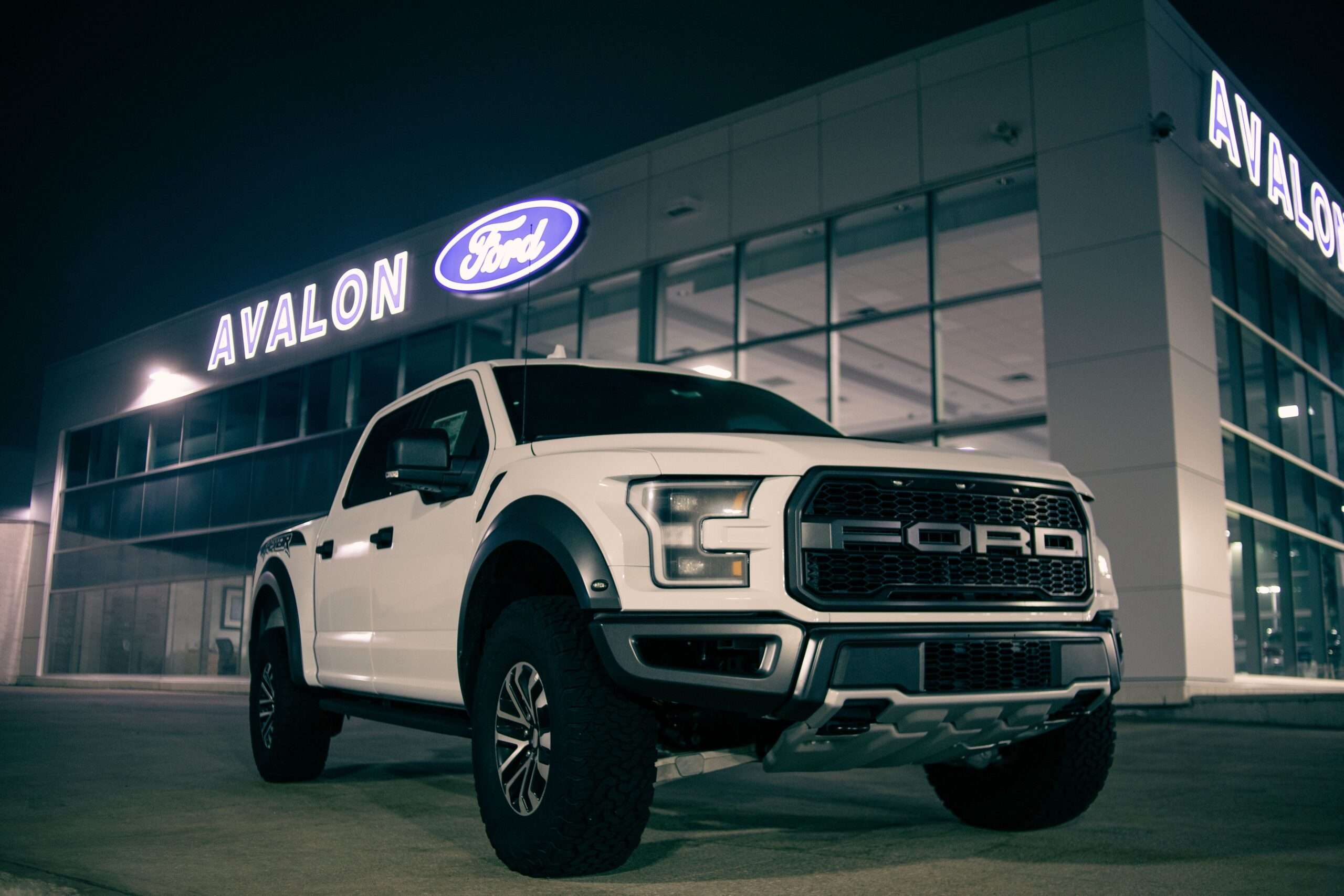 White county-style pickup truck parked outside a building
