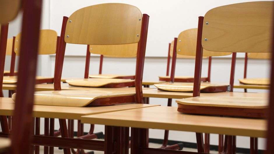 An empty classroom with rows of desks in a Mobile County public school building