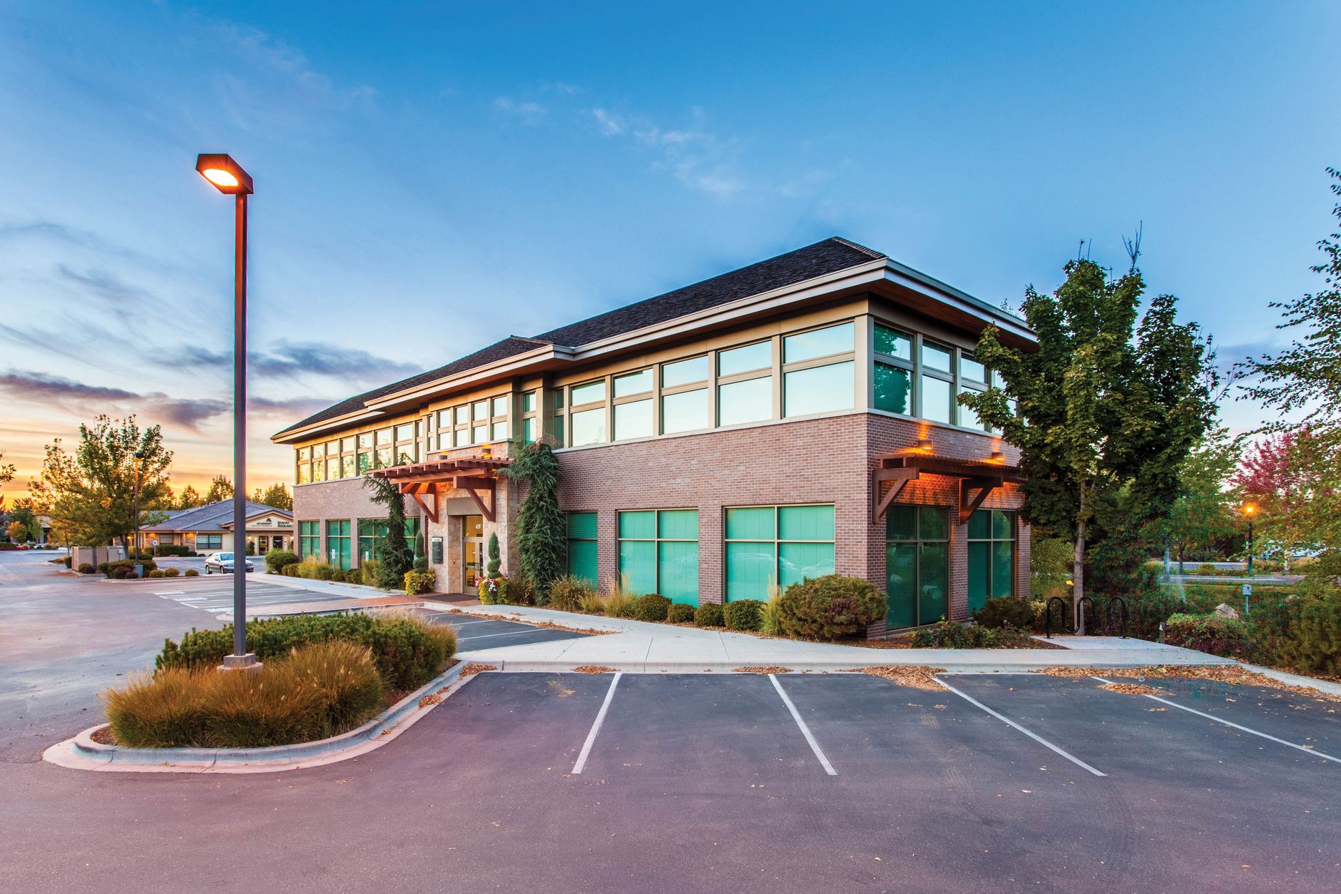 Low-rise suburban office building with a large parking lot