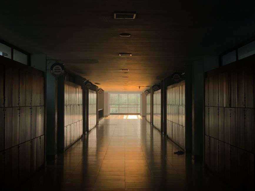 Empty school hallway lined with lockers during a precautionary lockdown