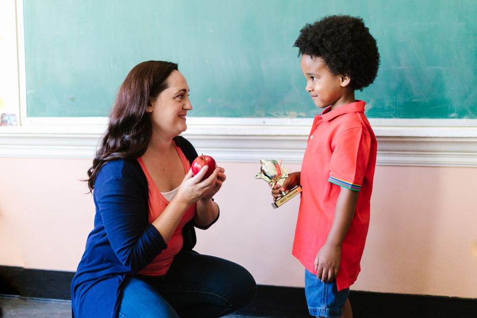 A teacher being honored with an award in a classroom setting