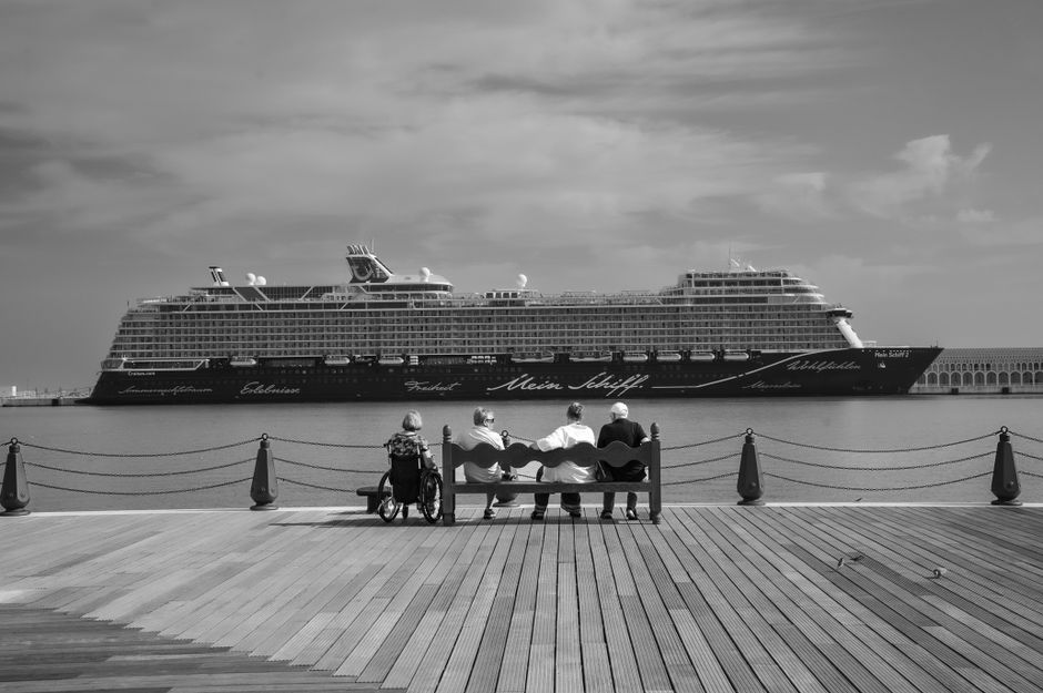 Cruise passengers and staff at a coastal cruise terminal