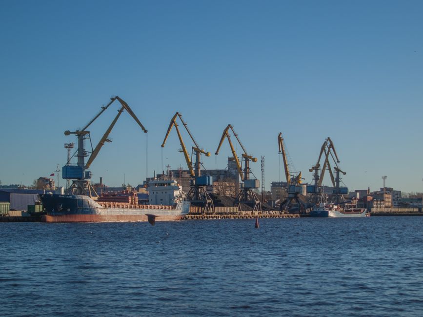 Shipping containers and cargo vessels at a port harbor