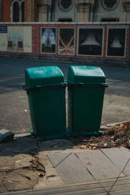 Recycling cart placed curbside outside a downtown storefront