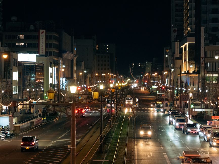 A downtown city street with nightlife venues