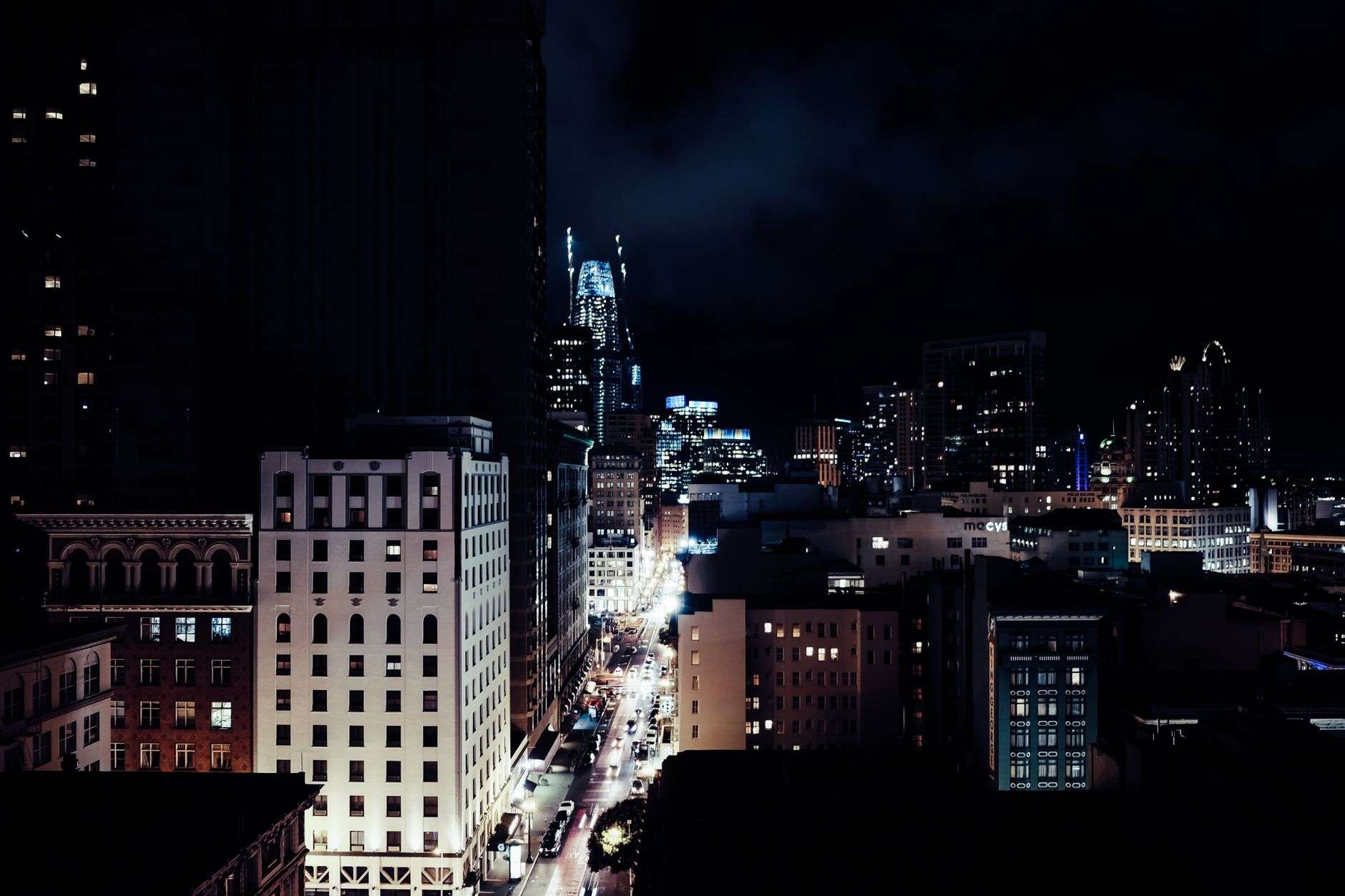 Empty downtown street lit by streetlights at night, similar to areas covered by Mobile teen curfew ordinance