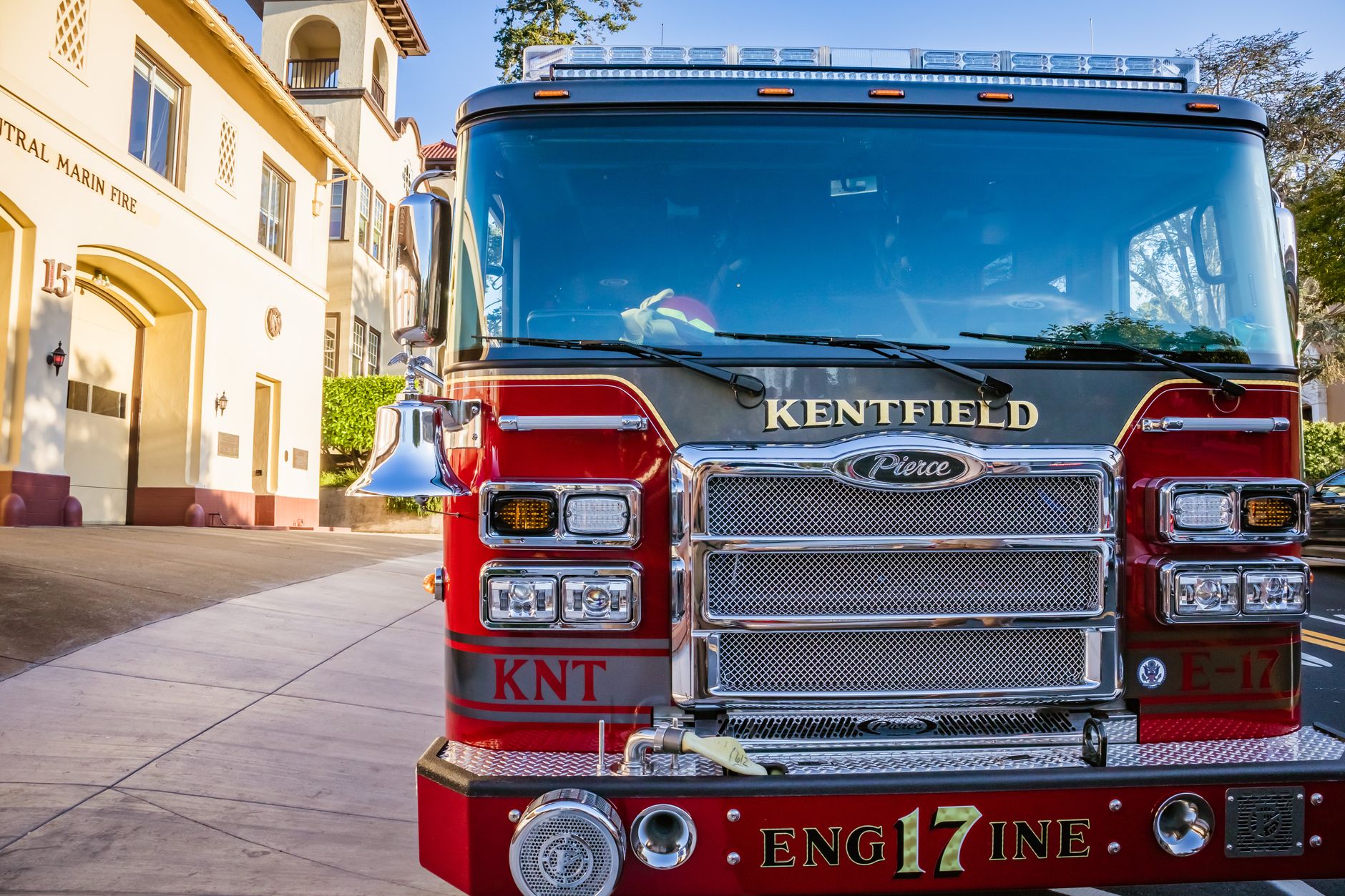 A fire engine parked inside the bay of a municipal fire station